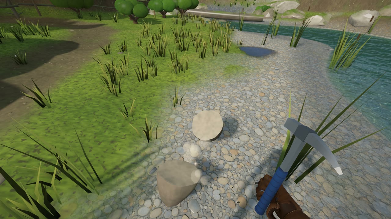 A rock hammer over a gravel bank, split stones on the ground